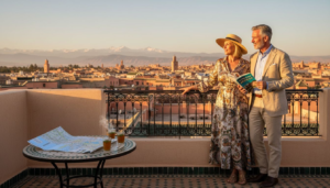 Luxury travelers on riad terrace at sunset