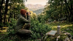 Wildlife watcher in Atlas foothills overlooking Moroccan landscape