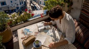 Traveler planning itinerary at Moroccan riad table