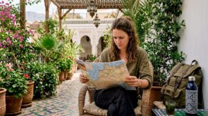 Traveler consulting map in Moroccan riad courtyard